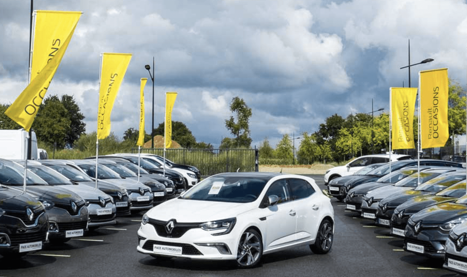 Voiture blanche entourée de voitures foncées
